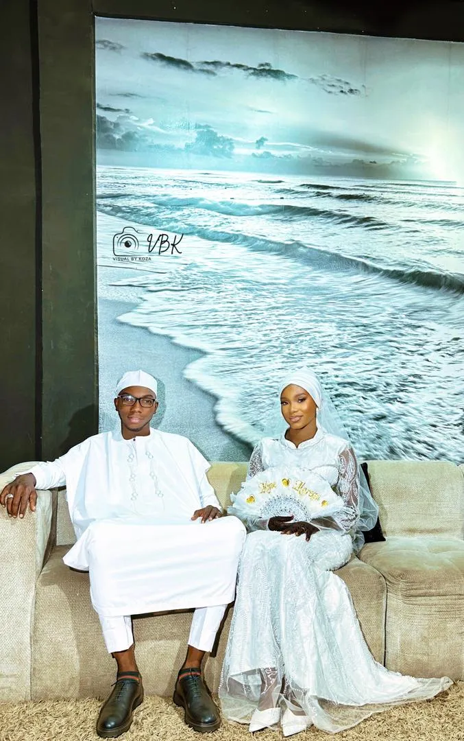 Couple seated before an ocean backdrop