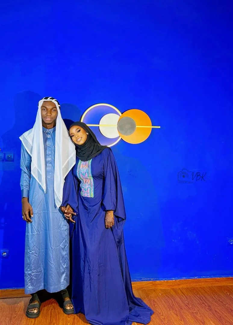 Couple in indigo against a royal blue studio wall