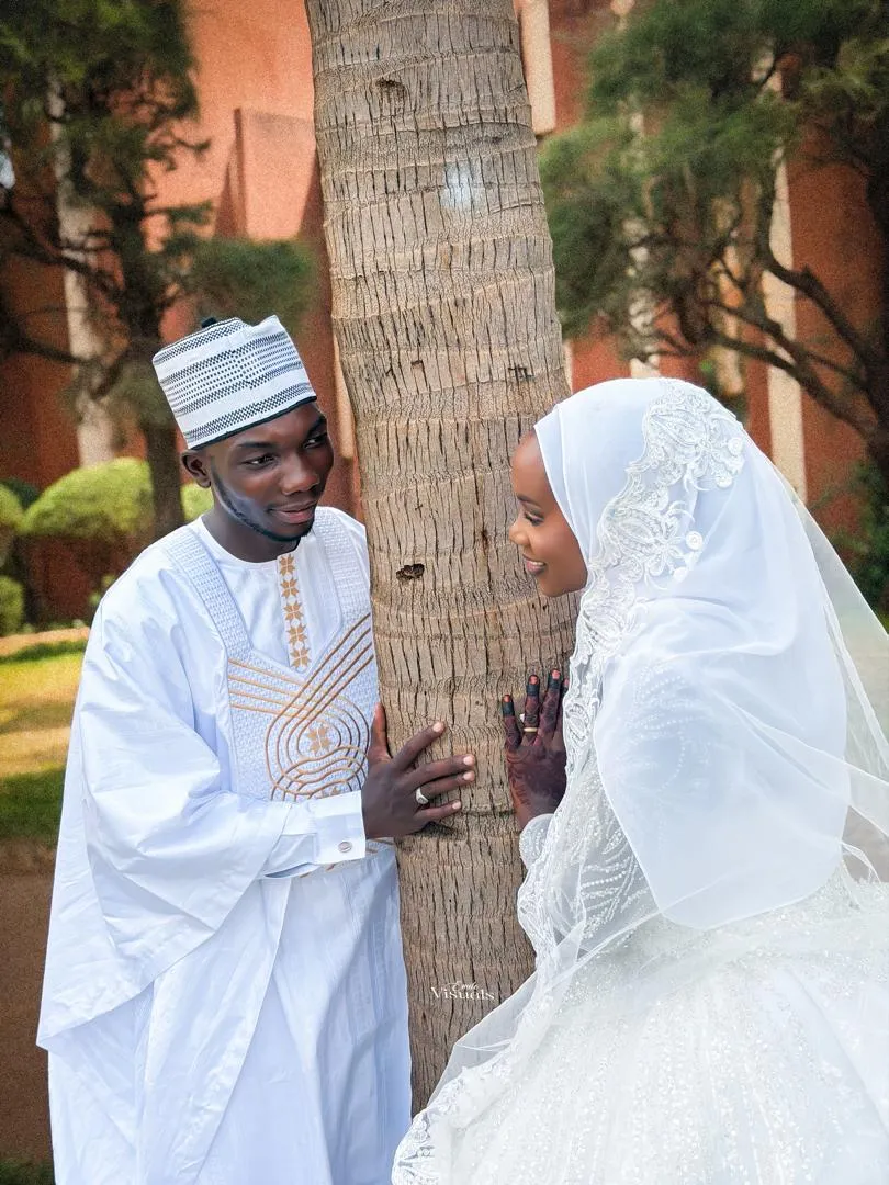 Groom and bride sharing a look under the palms
